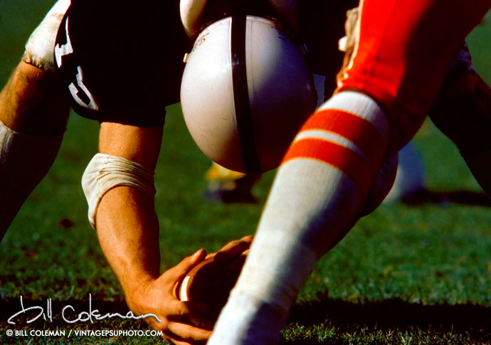 closeup of football player centering ball